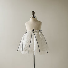 Load image into Gallery viewer, White tulle skirt with black ribbons on a mannequin against a plain background